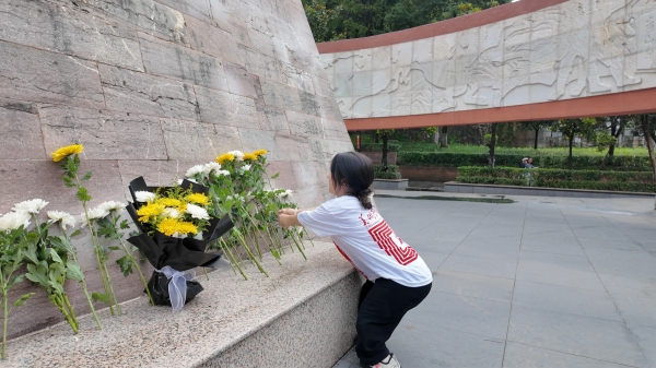 屈美芸在烈士纪念碑前献花。MILE米乐集团美术学院供图